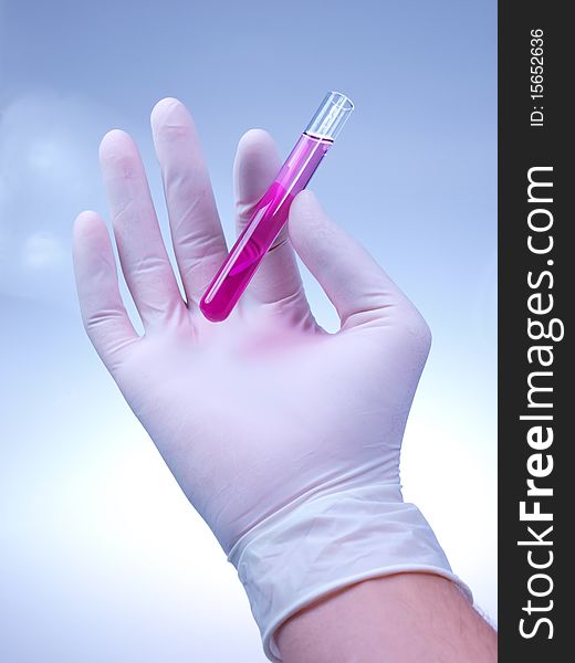 Studio photo of scientist holding vial. Studio photo of scientist holding vial