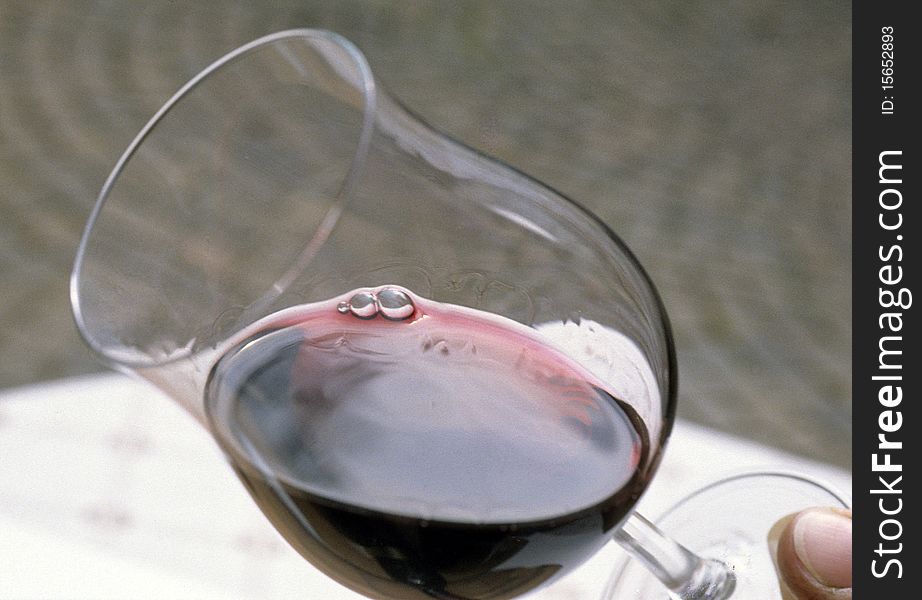 Glass of red wine angular holding