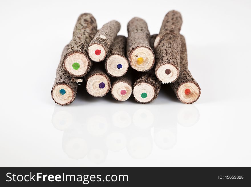 Coloured handmade original bark pencils on white background pointing with the back to the camera. Coloured handmade original bark pencils on white background pointing with the back to the camera.