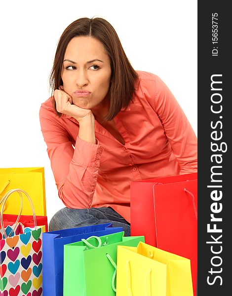 Brunette woman sitting in the middle of colored shopping-bags. Brunette woman sitting in the middle of colored shopping-bags