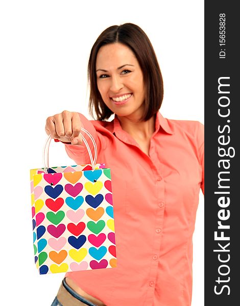 Young brunette Woman holding a colored bag with hearts. Young brunette Woman holding a colored bag with hearts