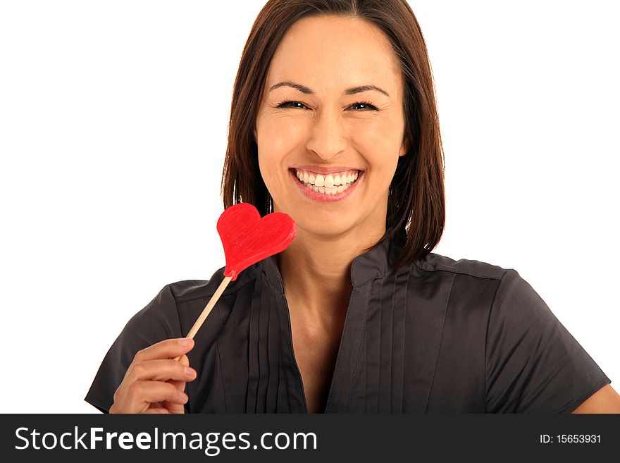 Beautiful young woman holding a sugar heart. Beautiful young woman holding a sugar heart