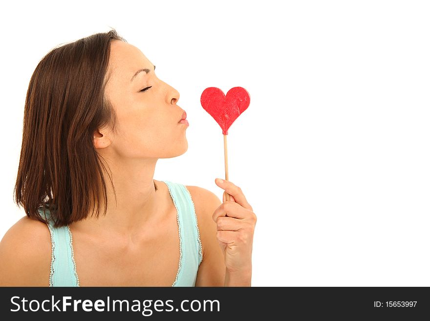 Beautiful young woman holding a candy heart. Beautiful young woman holding a candy heart