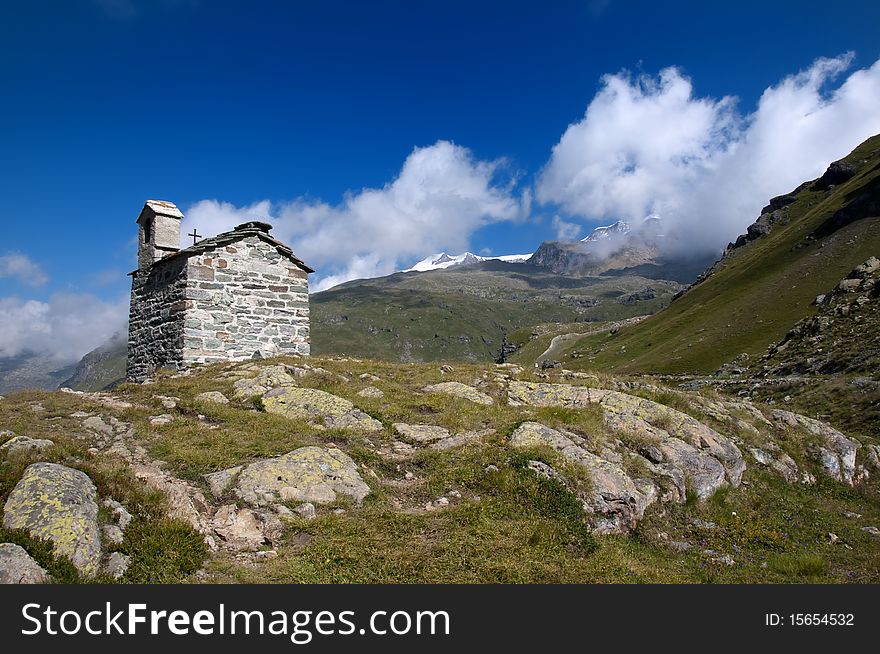Caption of alpine landscape with church. Caption of alpine landscape with church
