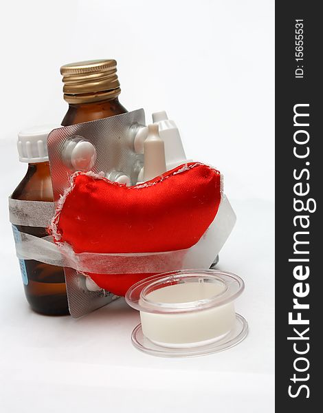 Medical components and heart on white background.