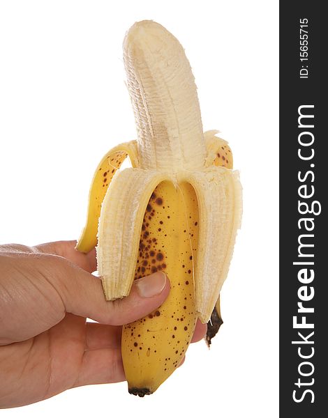 Hand holding peeled banana