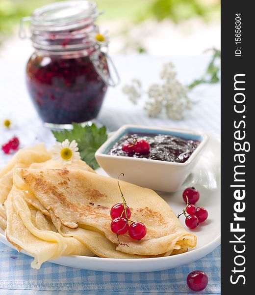 Pancakes with red currant jam for breakfast. Pancakes with red currant jam for breakfast