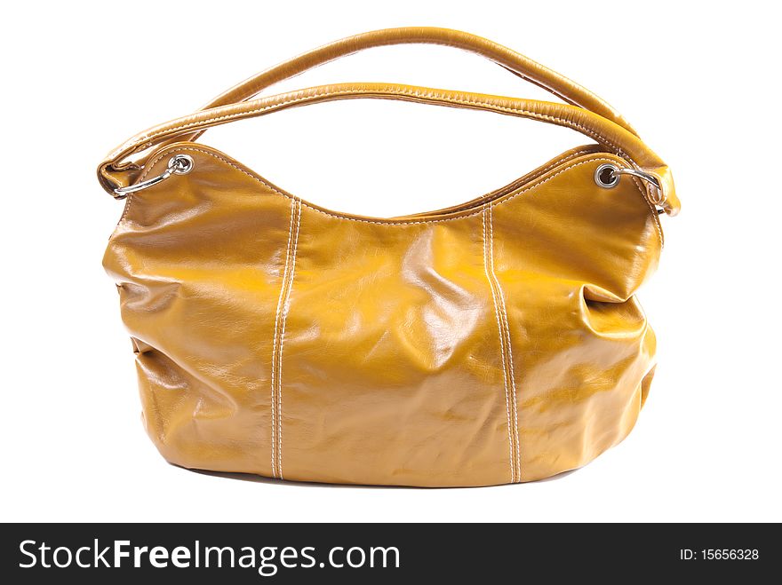 Yellow female handbag made of leather. Isolated on white background. Yellow female handbag made of leather. Isolated on white background