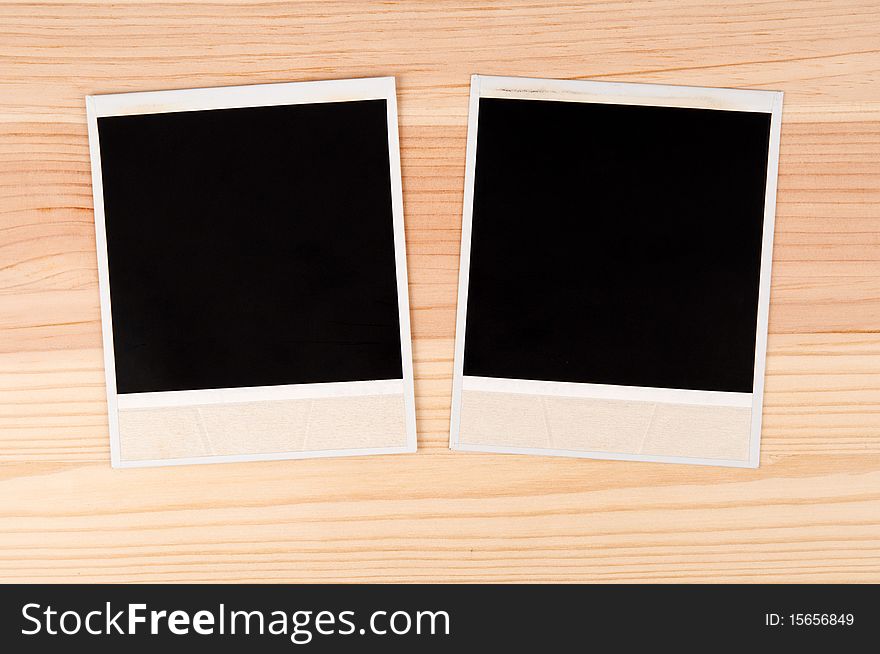 Two old photo frames on a wooden background