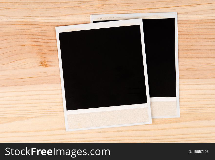 Two old photo frames on a wooden background