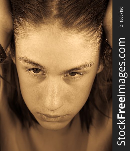 Monochrome portrait of a attractive teenager with shaggy hair, head in hands. selective focus. Monochrome portrait of a attractive teenager with shaggy hair, head in hands. selective focus.