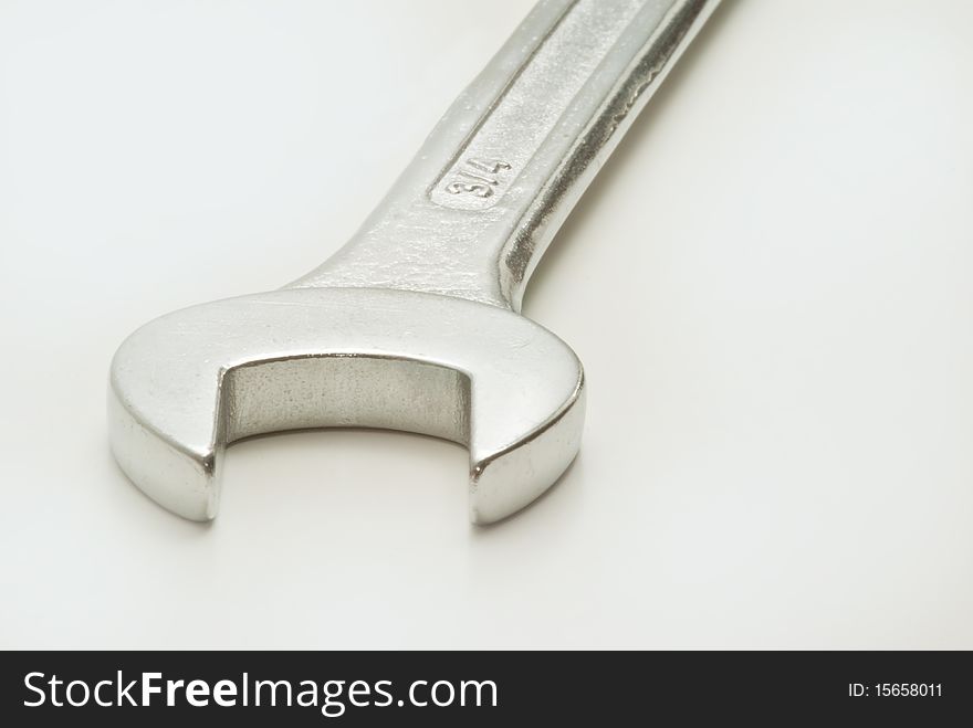 Closeup of single spanner on white background