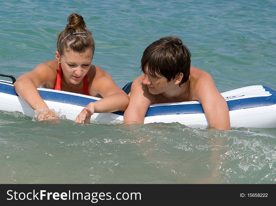 Boy and girl swimming in the sea
