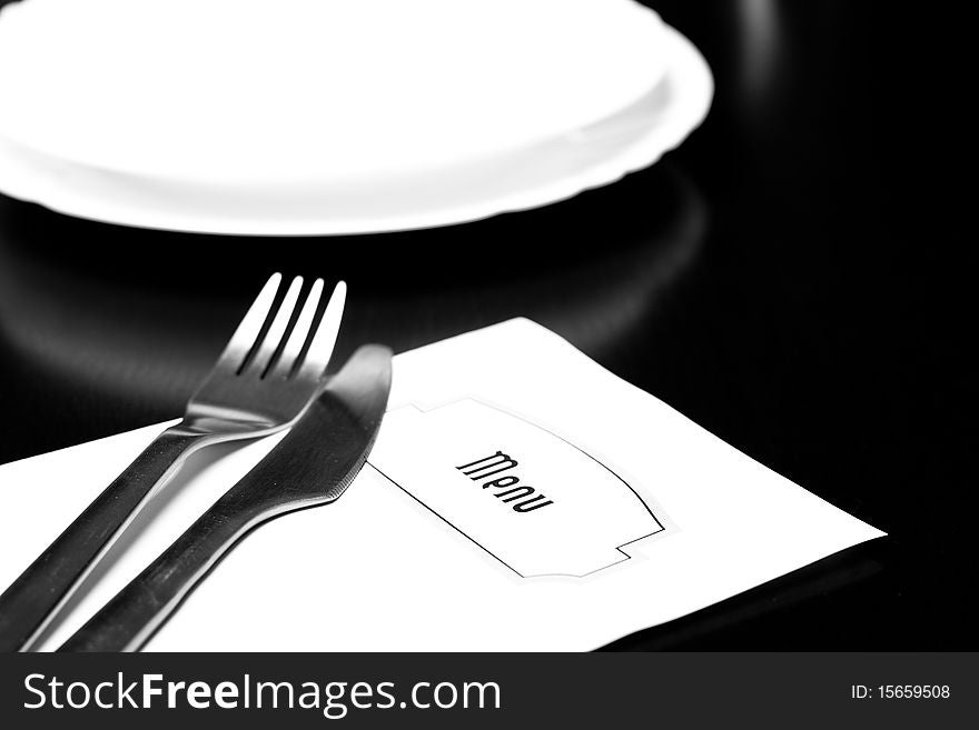 Silverware and a menu on a restaurant table