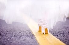 The Bride Goes Along The Yellow Line Along The Road Royalty Free Stock Photography
