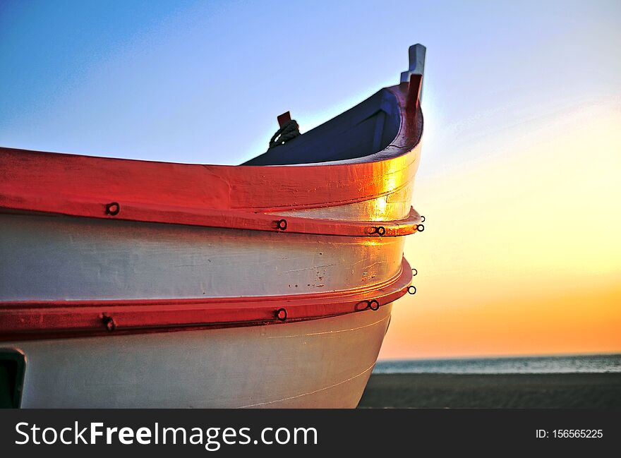 Traditional wooden fisher boat on sunset, Portugal