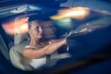 Young Female Driver Driving Her Car At Night Stock Photo Young Female Driver Driving Her Car At Night Stock Photo