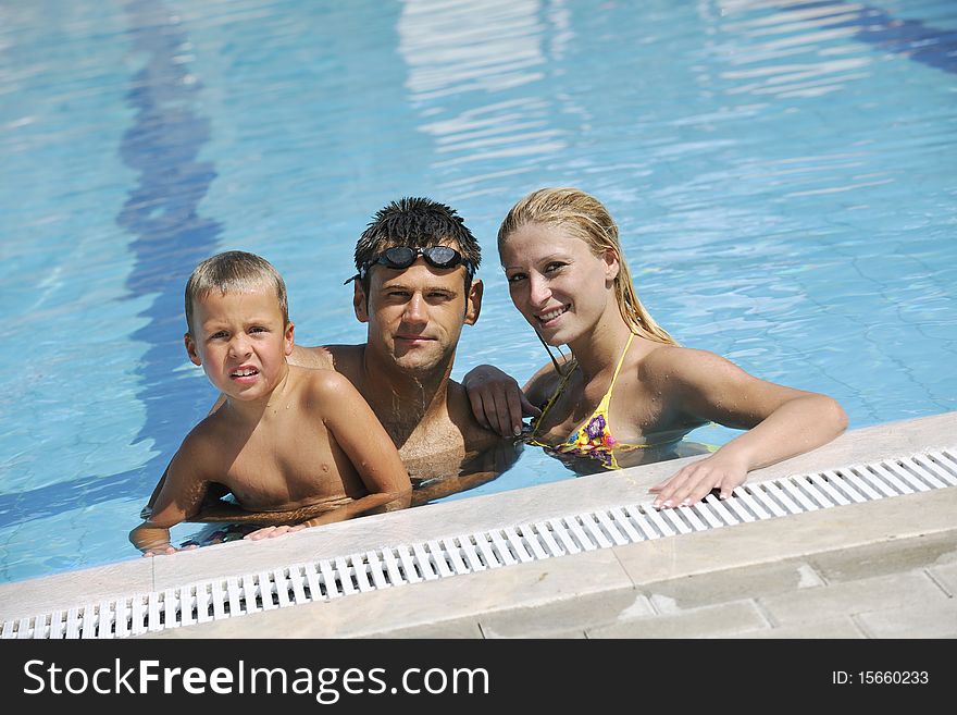 Happy young family have fun on swimming pool