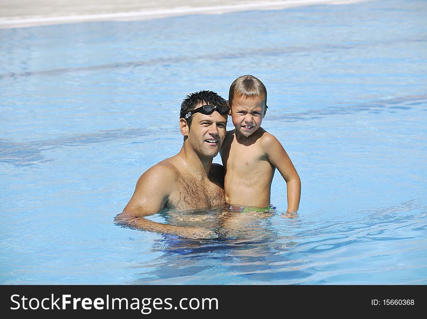 Happy father and son have fun at swimming pool. Happy father and son have fun at swimming pool