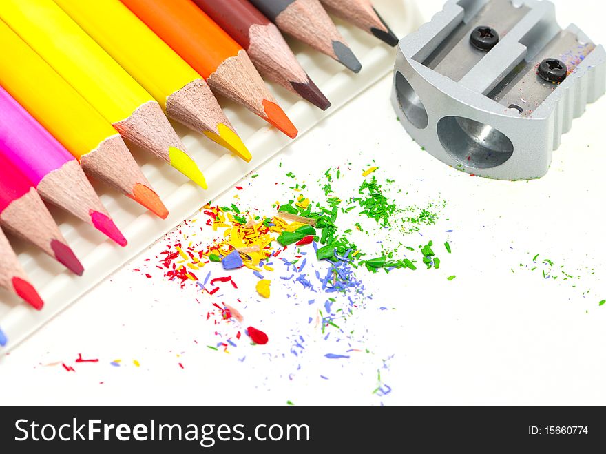 Pencils with a sharpener and shaving on a white background