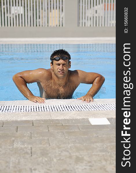 Young athlete man relax at swimming pool. Young athlete man relax at swimming pool
