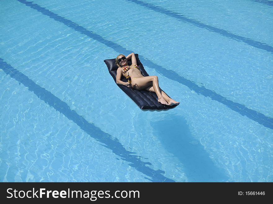 Beautiful young woman enjoy sun and coctail dring relaxing and have fun at siwmming pool. Beautiful young woman enjoy sun and coctail dring relaxing and have fun at siwmming pool