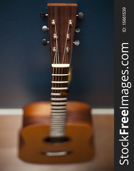 Guitar Against A Blue Wall