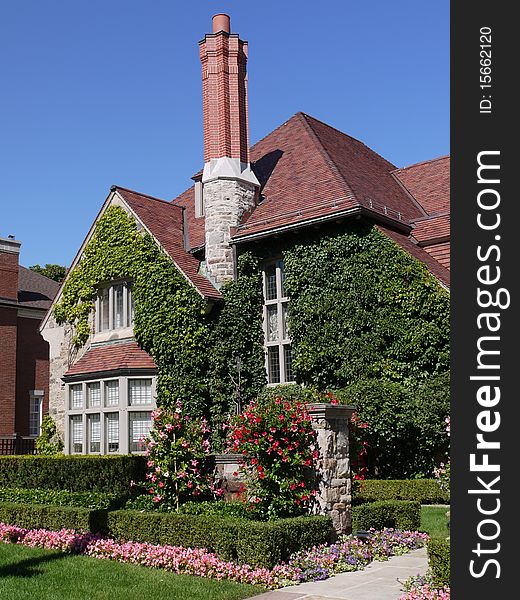 A nicely landscaped entrance with bright pink flowers. A nicely landscaped entrance with bright pink flowers.