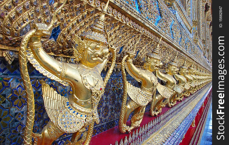 Thailand. The Grand Palace. Temple of the Emerald Buddha. Gold ornamental patter statuettes.