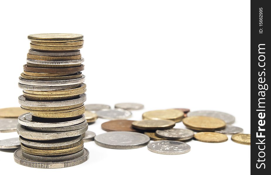 Many coins in copper and silver stacked up on a pure white background with space for text