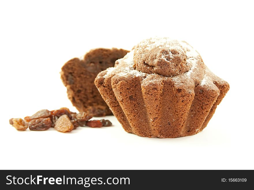 Brown home baked cupcake with raisins. Isolated on white background