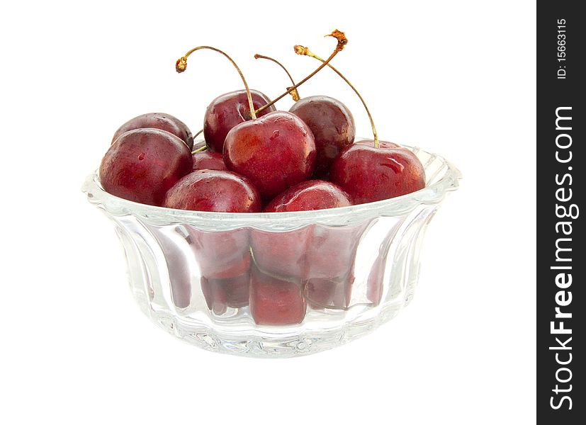 Cherries on glass bowl. Isolated on a white background. Cherries on glass bowl. Isolated on a white background