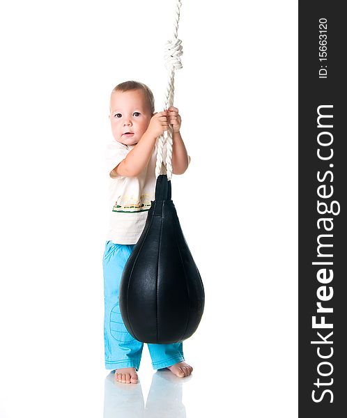 Cute little boy with the punching bag