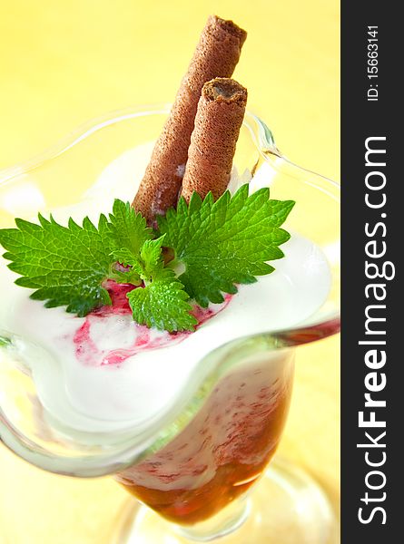 Cream with berries and mint in a glass vase