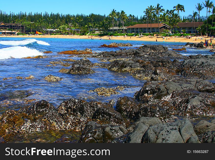 Waves crash on the shore in a tidal pool zone on the Hawaiian coast. Waves crash on the shore in a tidal pool zone on the Hawaiian coast.