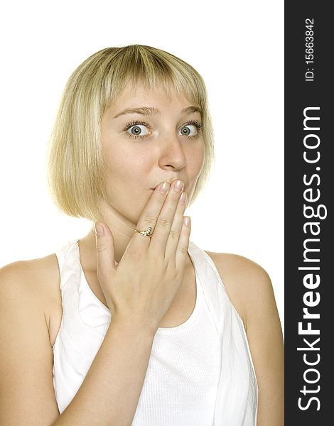 Close up young woman surprised covers mouth with his hand on a white background. Close up young woman surprised covers mouth with his hand on a white background