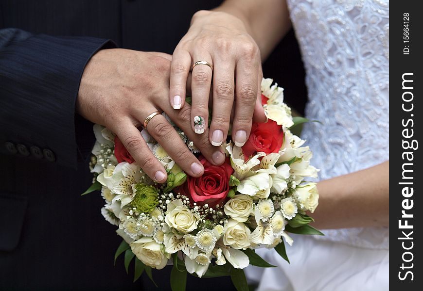 Caucasian mid-adult male and female hands with wedding rings