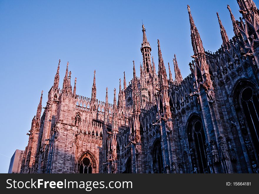 Milan Cathedral at sunset turns red against a blue sky, milan, Italy