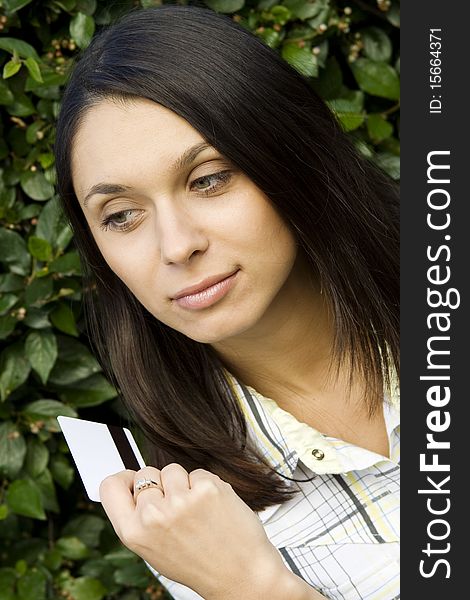 Young beautiful woman outdoors with a plastic credit card. Young beautiful woman outdoors with a plastic credit card