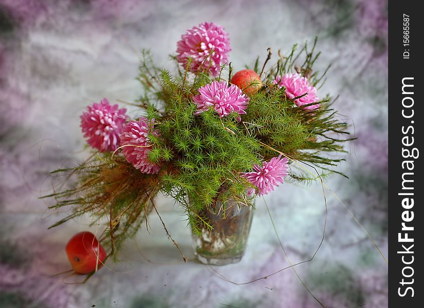 In glass moss and flowers of chrysanthemum stand an apple lies alongside. In glass moss and flowers of chrysanthemum stand an apple lies alongside