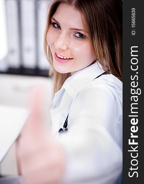 Happy young female doctor showing thumbs up sign