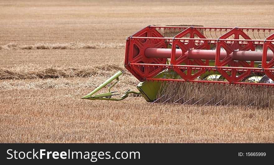 Close up of the harvester blades splitting the wheat. Close up of the harvester blades splitting the wheat