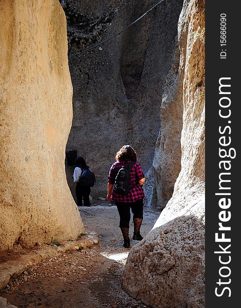 A tourist woman hiking between cliffs in syria. A tourist woman hiking between cliffs in syria