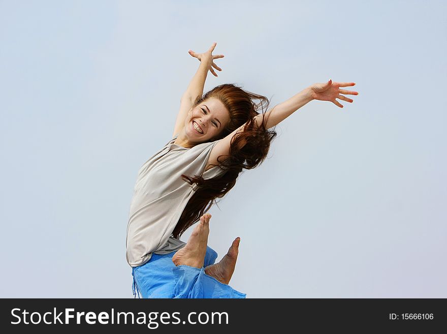 Young happy girl jumping isolated