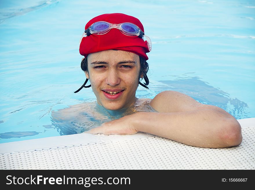 Boy in the swimming pool with the cap