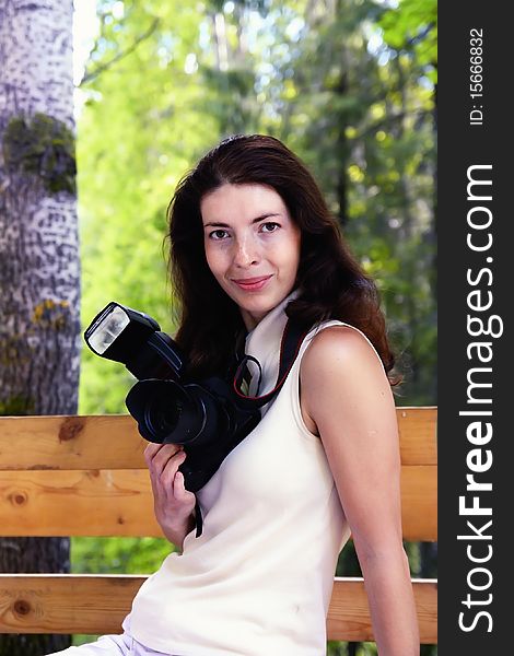 Photographer girl is sitting on the street. Photographer girl is sitting on the street