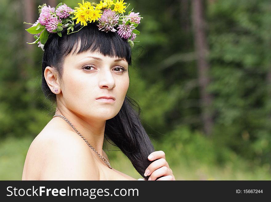 Portrait of a beautiful girl with flowers on head