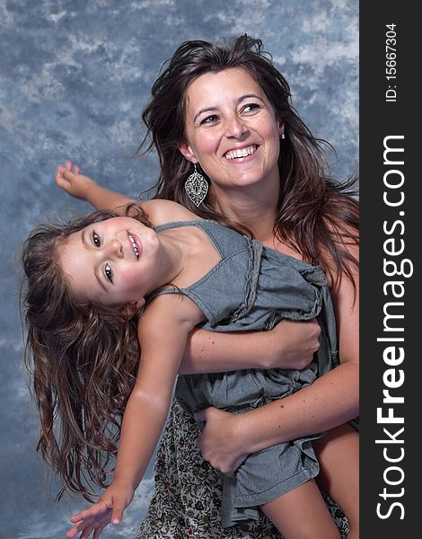 Mother and daughter play on studio
