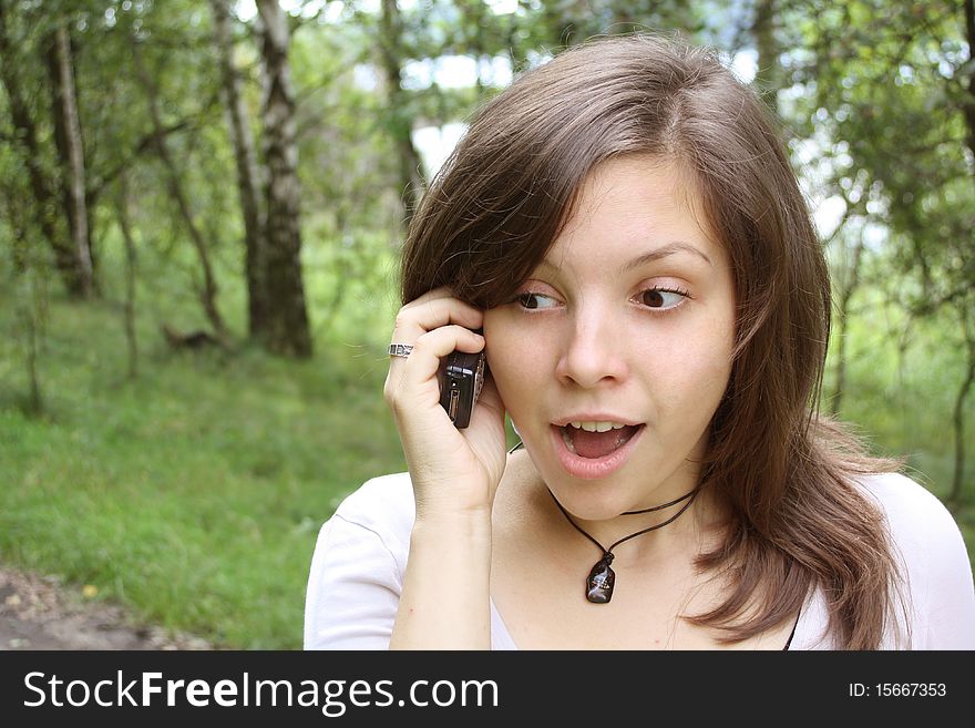 Young woman are phoning and she is shocking