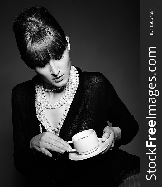 Beautiful retro woman with red lips holding cup of coffee. black and white picture. Beautiful retro woman with red lips holding cup of coffee. black and white picture